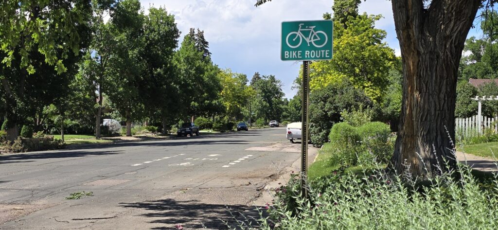 Bike Route along Corona Street near Fontanero Street in Colorado Springs. A bike route or bike boulevard is where drivers and riders must share the traffic lanes because there is not bike lane. Drivers will be reminded to share the street by a green and white "bicycle route" sign and a lane-marking with "Bike Blvd" lettering and a bicycle symbol.